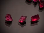 Red Gemstones on a Black Surface