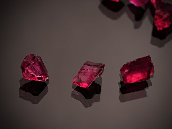 Red Gemstones on a Black Surface